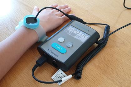 Low intensity pulsed ultrasound machine strapped to a patients wrist